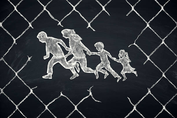 refugees border fence stock photo