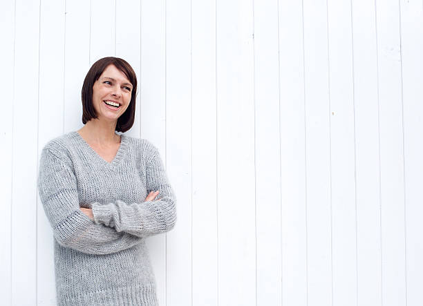 istock Smiling older woman standing against white background 490278142