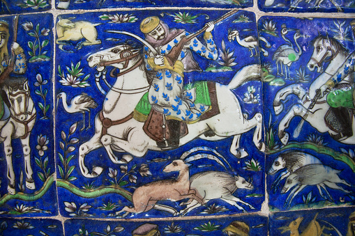 Isfahan, Iran - October 15, 2014: Vintage ceramic tiles of the 19th century with hunting scene and a horse rider on October 15 2014. Third largest city in Iran, Isfahan is outstanding example of Islamic culture