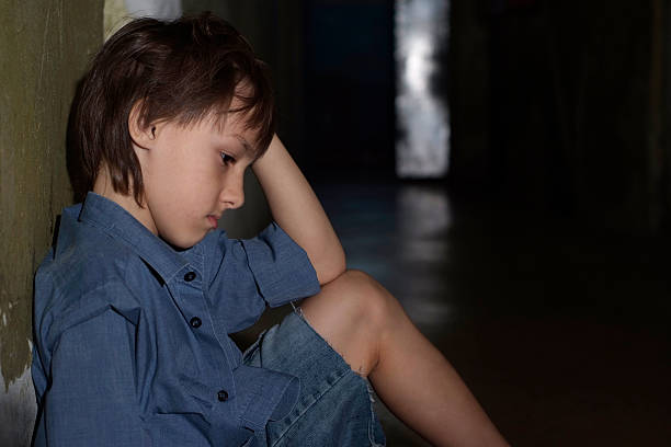 istock Sad kid in dark room 490278870