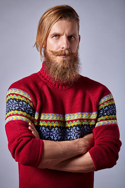 istock Bearded man with curled mustache knit red sweater standing 490283836
