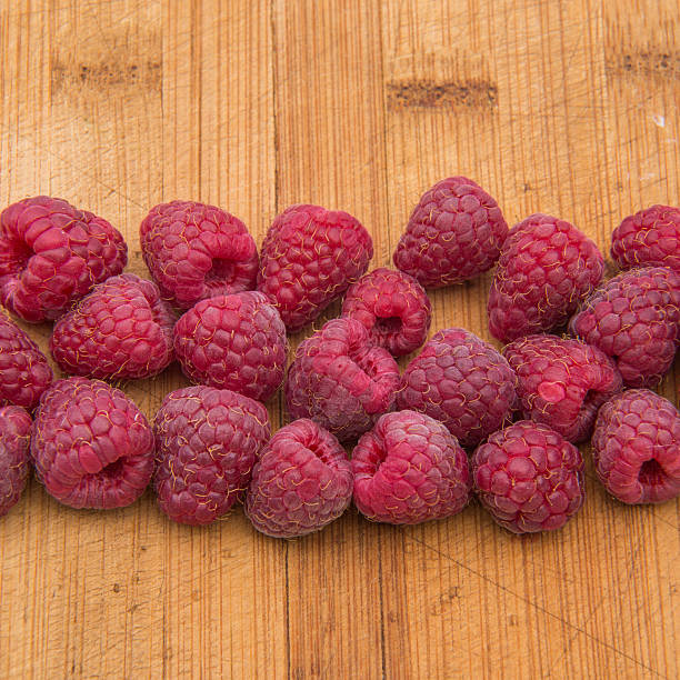 istock Ripe sweet raspberries on wood table close-up 490285690