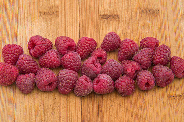 istock Ripe sweet raspberries on wood table close-up 490285974