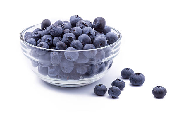 istock ripe blueberries in bowl isolated on white 490286418