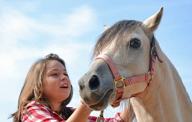 istock Child han her horse 490286462