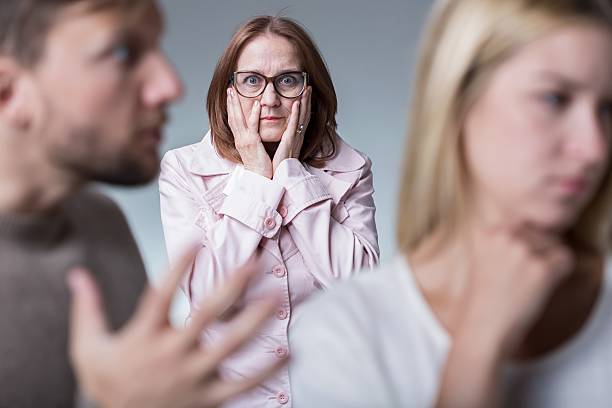 Argument in family Mother-in-law interfering with young couple having argument annoying mother in law stock pictures, royalty-free photos & images