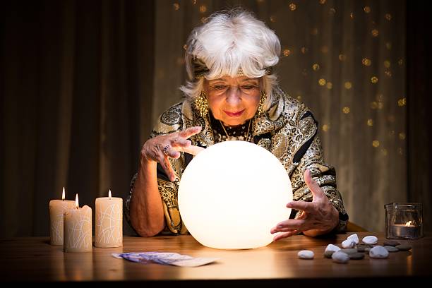 Foretelling future from crystal ball Photo of woman foretelling future from crystal ball fortune teller photos stock pictures, royalty-free photos & images
