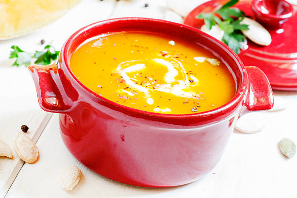 istock Pumpkin soup in a red bowl 490286840