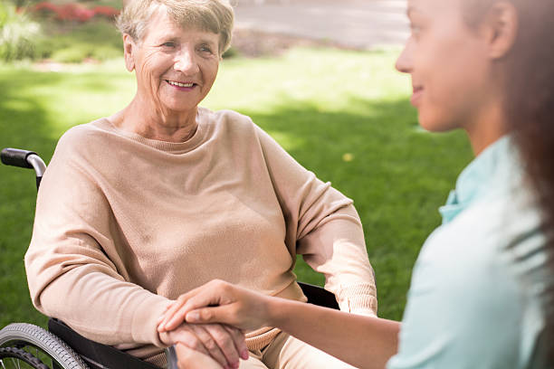 istock Senior woman and caring nurse 490303428