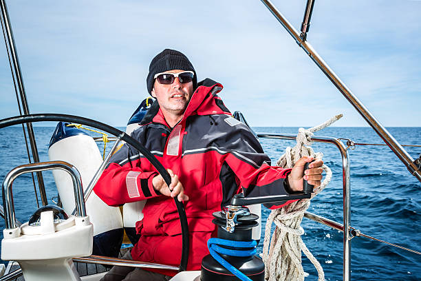 istock Happy skipper on sailboat 490304402