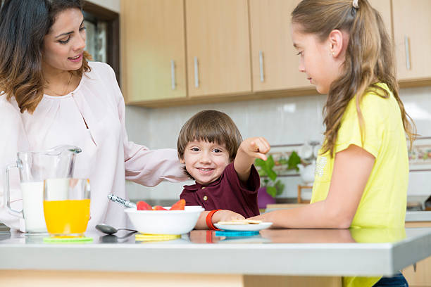 istock Lovely  Mother and her children having breakfast 490304930
