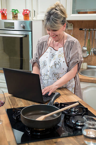 istock Smiling woman typing on laptop at home. 490305146