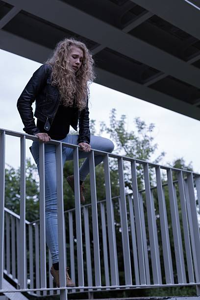 istock Suicide female standing on bridge 490305362