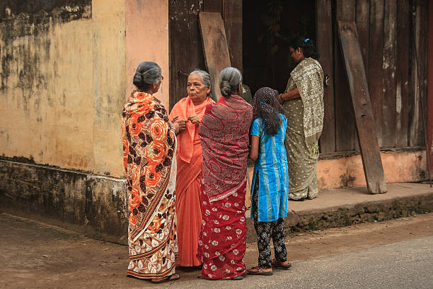 Kochi (Kerala), India - November 27, 2009: Women in vibrant saris gather at a corner to talk. Shot in the old town of Kochi (Cochin).