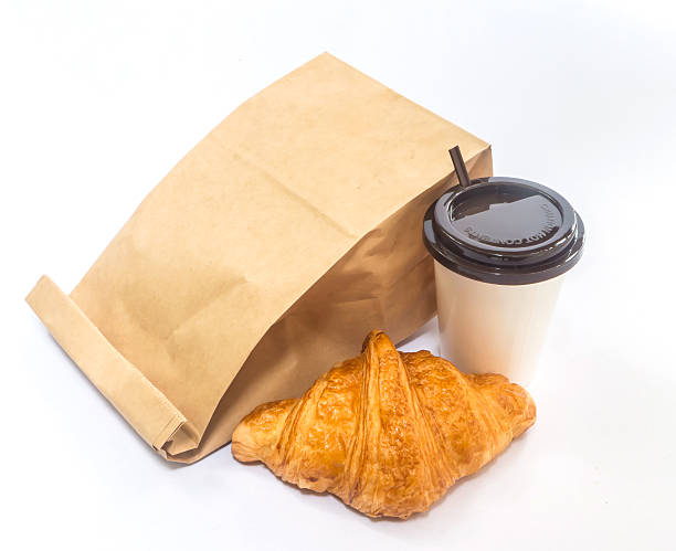 istock coffee and croissant with paper bag isolated 490309668