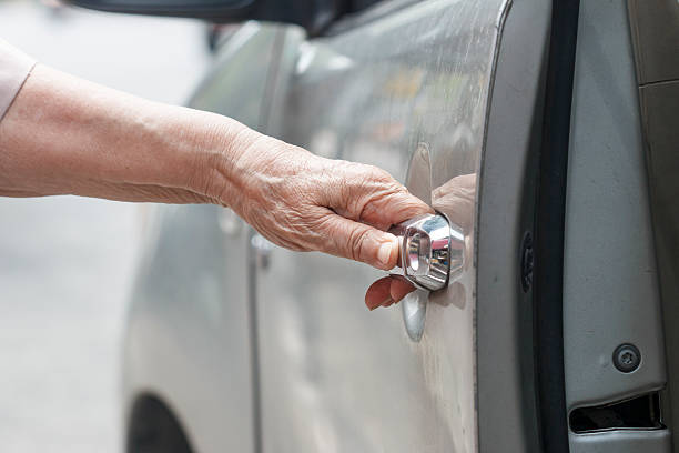 istock senior woman open car door 490310106