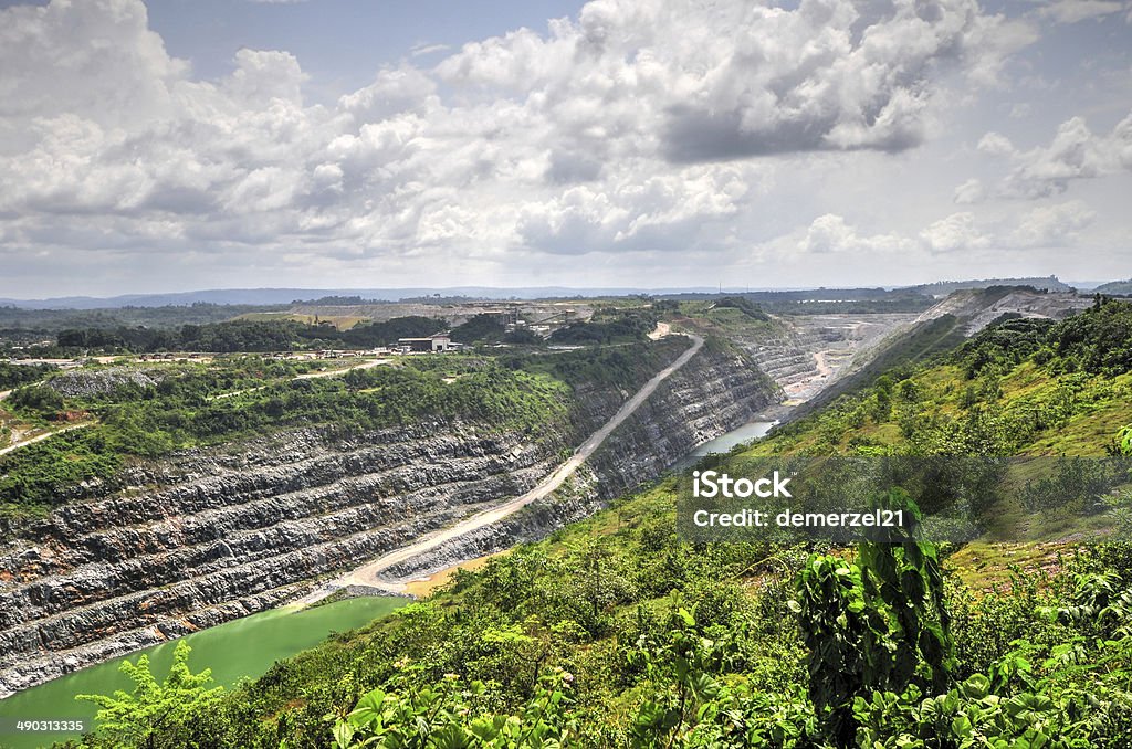 Open Pit Gold Mine, Africa Open Pit Gold Mine in Ghana, Africa with a view of the cut out earth. Mining - Natural Resources Stock Photo