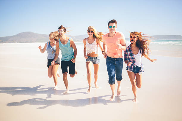 istock Friends running along the beach 490314645