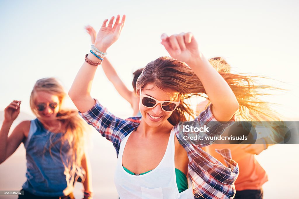 Woman dancing friends on beach in sunset Friends dancing on beach in sunset Beach Stock Photo