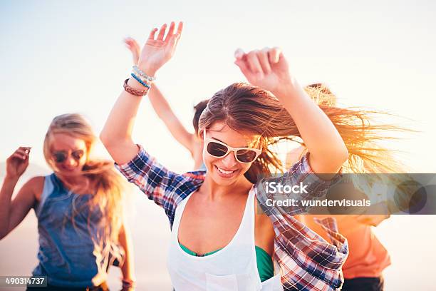 Woman Dancing Friends On Beach In Sunset Stock Photo - Download Image Now - Beach, Dancing, Retro Style