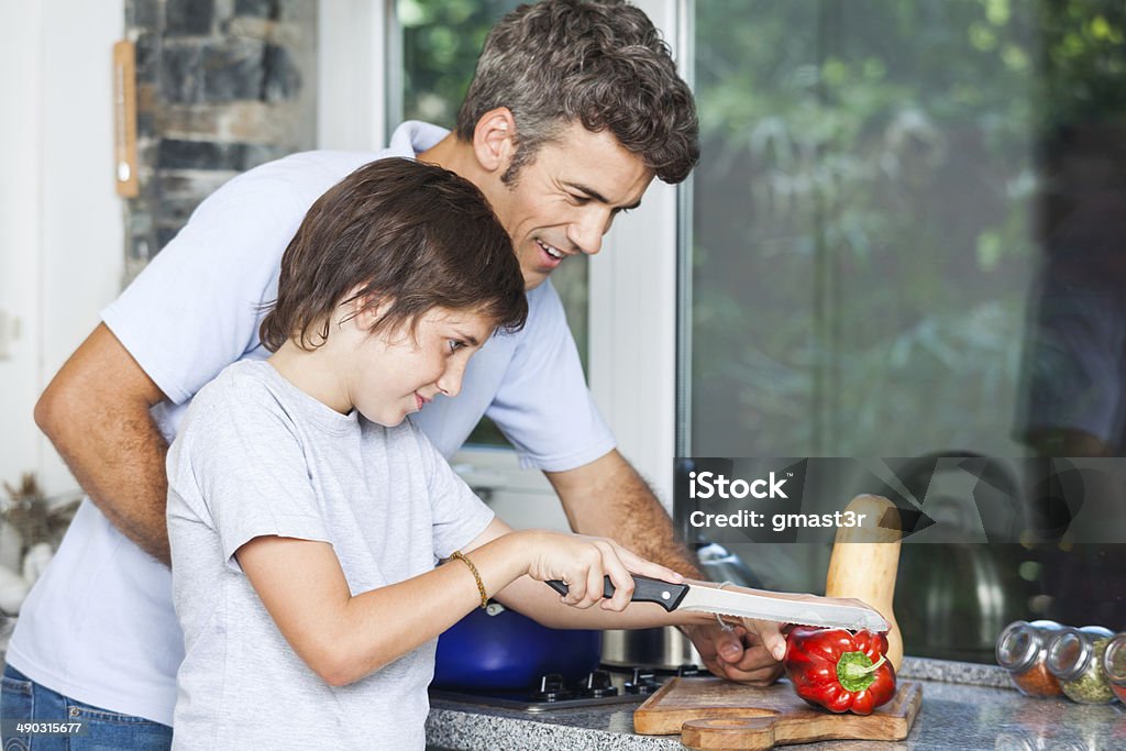 father and son cooking home kitchen, slicing father and son smile cooking at home kitchen, slicing vegetables Cooking Stock Photo