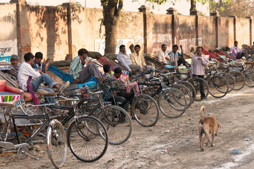 Varanasi, India - March 20, 2014: Indian rickshaw drivers waiting for their customers in Varanasi.