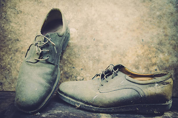 istock still life with boots on wooden table over grunge background 490318020