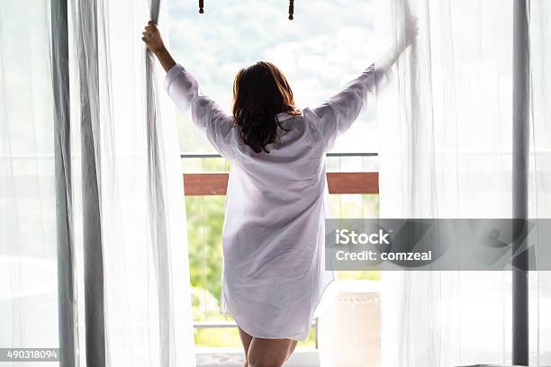 Asian Women Open The Curtain Stock Photo - Download Image Now - Opening, Window Blinds, Women