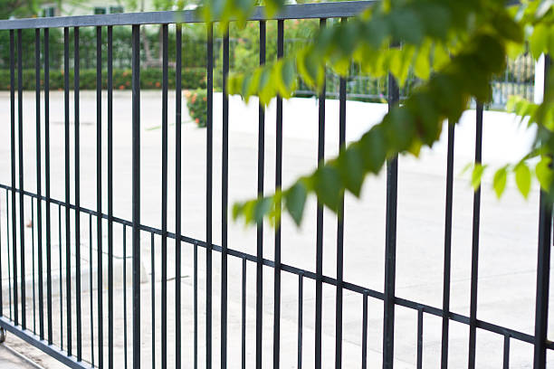 istock Metal fence with blur green leaves 490337538