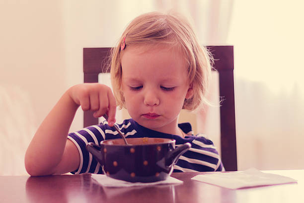 istock Little cute girl eats soup. 490339882