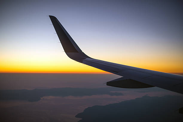 istock Wing of an airplane at sunset, view from window. 490340898
