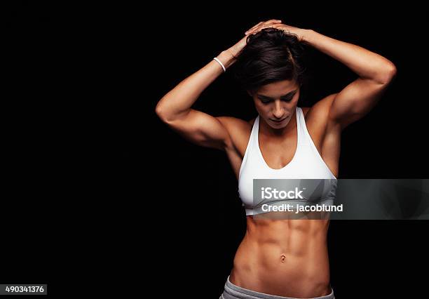 Female Athlete With Perfect Abs Stock Photo - Download Image Now - Dark, Looking Down, 2015