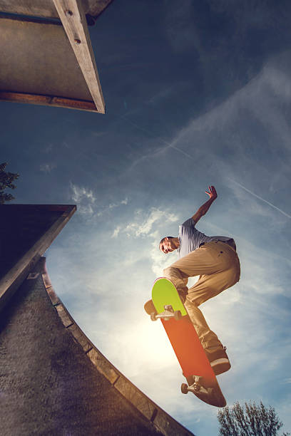istock Young skateboarder on a skate ramp against the sky. 490342122