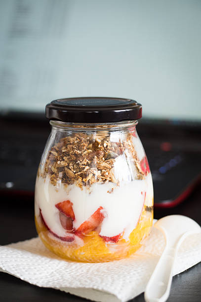 Granola with orange, strawberry and plain yogurt as lunchbox