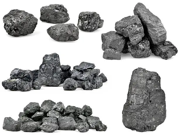 Set of piles of coal isolated on white background.