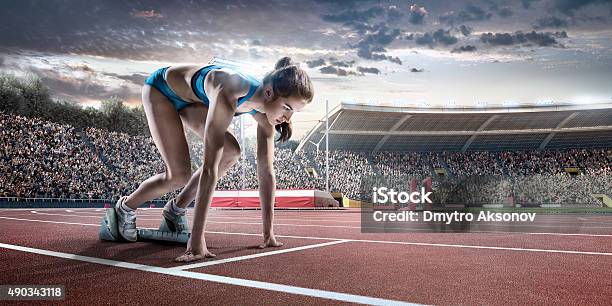 Female Athlete Prepares To Run Stock Photo - Download Image Now - American Football - Sport, Running, Stadium