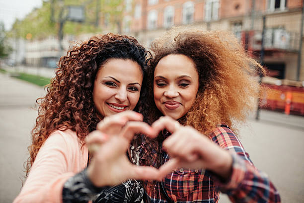 istock Beautiful young women making heart shape 490343260