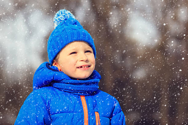 istock little boy enjoy first snow in winter nature 490343588