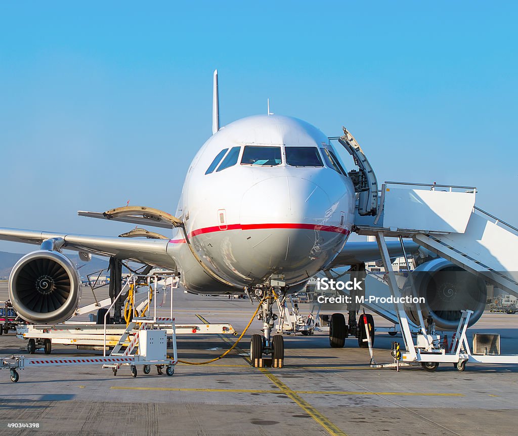 Passenger plane in the airport. Aircraft maintenance. 2015 Stock Photo