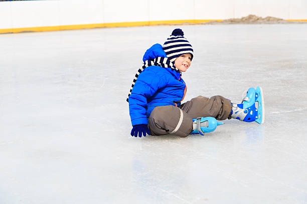 istock cute little boy learning to skate in winter 490346442
