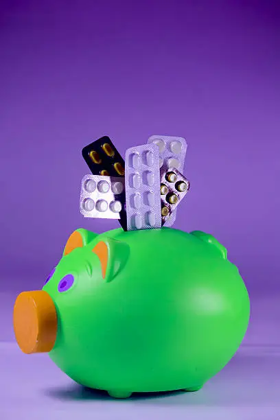 Pills in Blister packs with a Piggy Bank, Concept