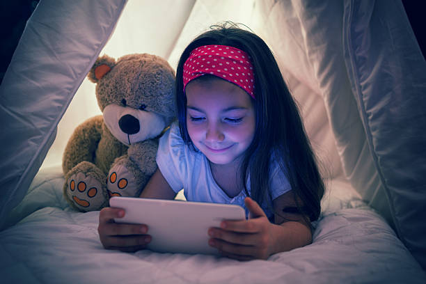 istock Little Girl Using Digital Tablet in Bed 490358930