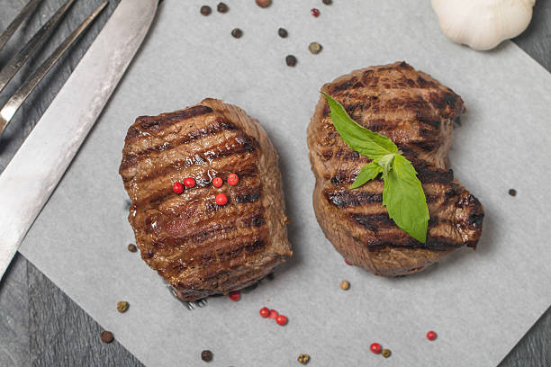 istock Grilled beef steak close up on paper 490360024