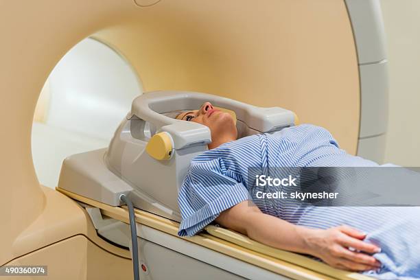 Woman About To Receive An Mri Scan Of Her Head Stock Photo - Download Image Now - Radiation, Physical Therapy, Cancer - Illness