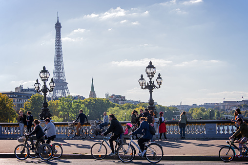 Paris, France - September 27, 2015: People on bicycles and pedestrians enjoying a car free day on Alexandre III bridge in Paris, France