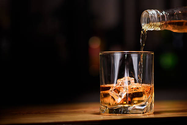 life. o whisky siendo vertido en vidrio - bebida alcohólica fotografías e imágenes de stock