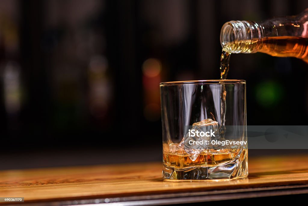 Still life. pour or whiskey in to glass Still life. pour or whiskey in to glass. Scotch Whiskey Stock Photo