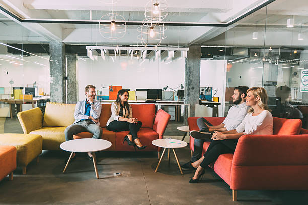istock Group of young people talking in modern cafe 490361240