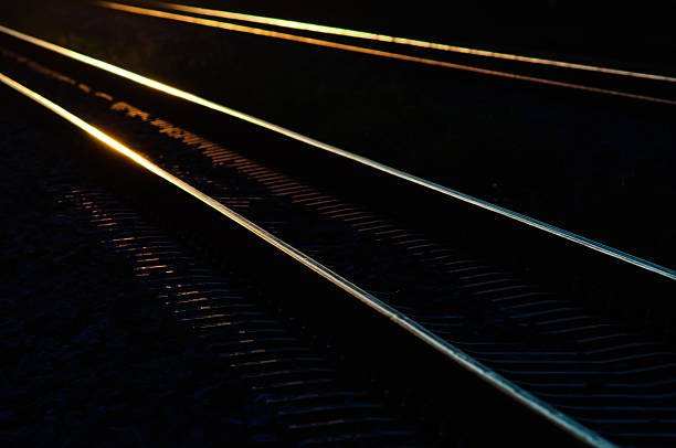 istock railway tracks in the shadow light of sunset. 490361330