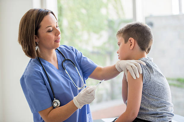 istock Nurse Giving Child a Shot 490362340